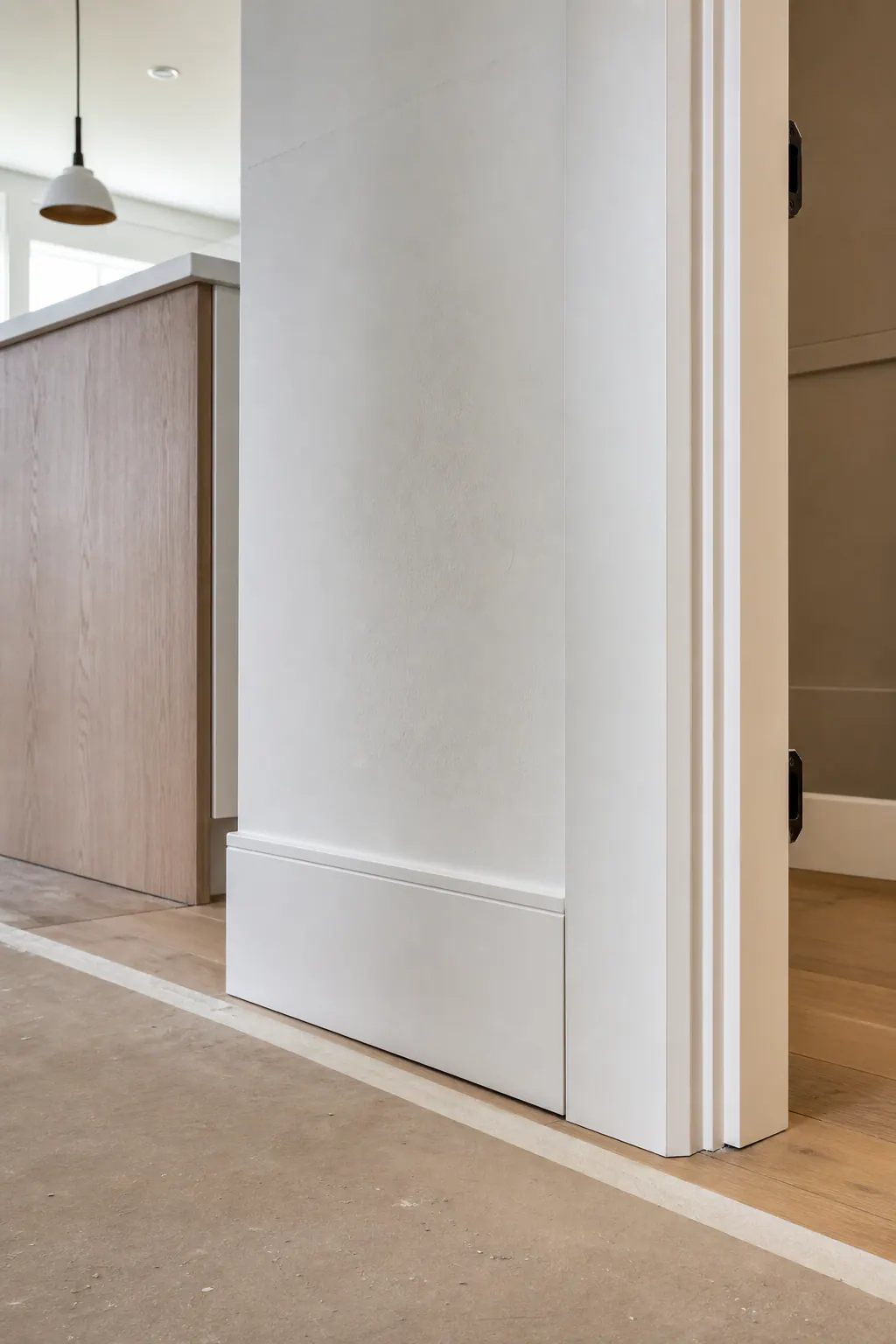 Trim Installation at Flooring and Cabinetry
